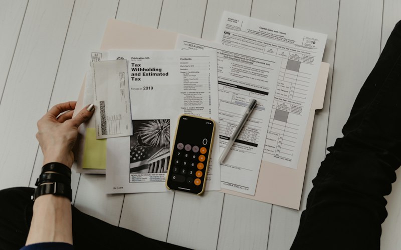 Accountant reviewing tax forms with a calculator